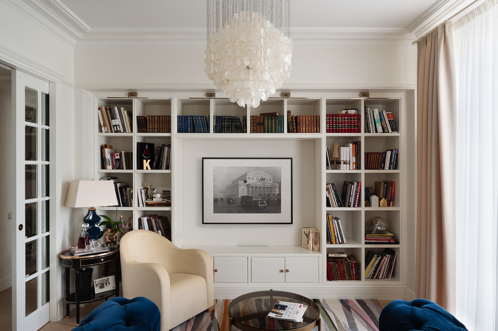Photo of a traditional open concept living room in Moscow with a library, white walls and carpet.