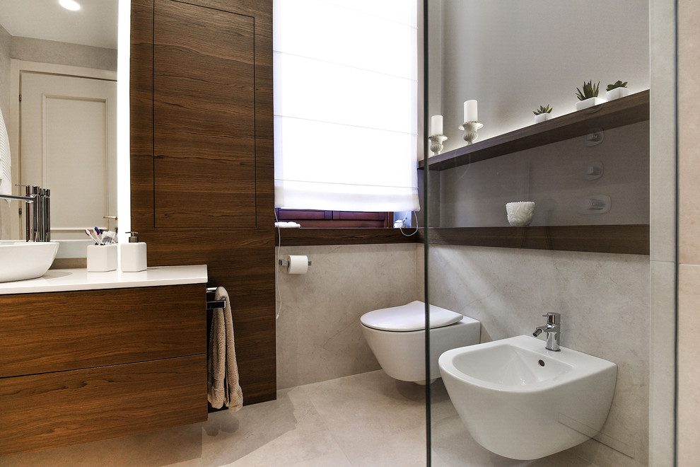 Small contemporary 3/4 bathroom in Other with beaded inset cabinets, dark wood cabinets, a curbless shower, a wall-mount toilet, beige tile, porcelain tile, beige walls, porcelain floors, a vessel sink, beige floor, an open shower, beige benchtops and limestone benchtops.