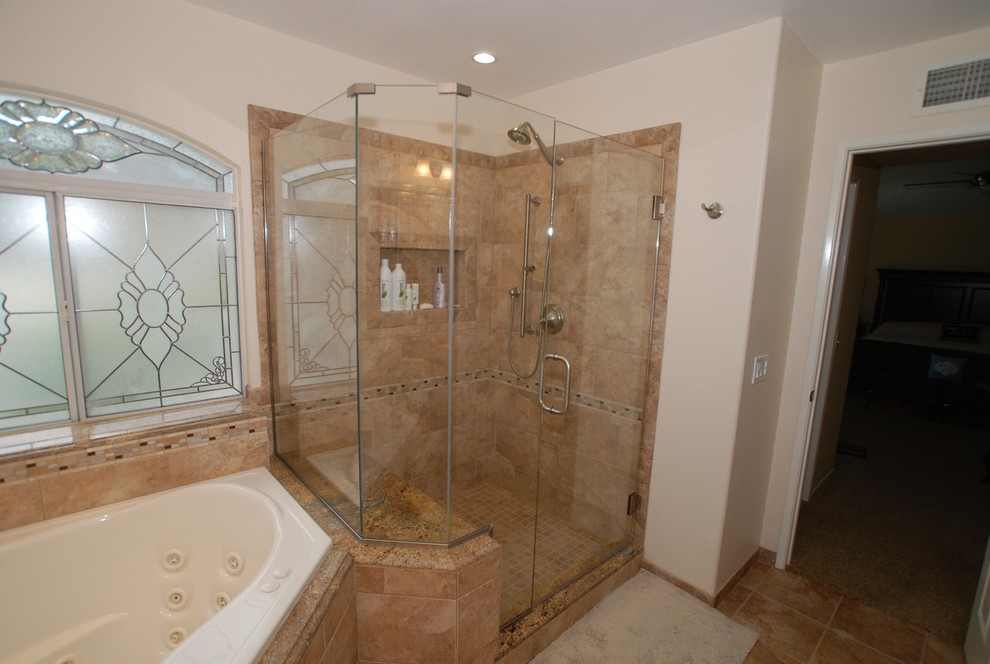 Photo of an expansive traditional master bathroom in Orange County with an undermount sink, raised-panel cabinets, dark wood cabinets, granite benchtops, a corner tub, a corner shower, a two-piece toilet, brown tile, porcelain tile, white walls and porcelain floors.