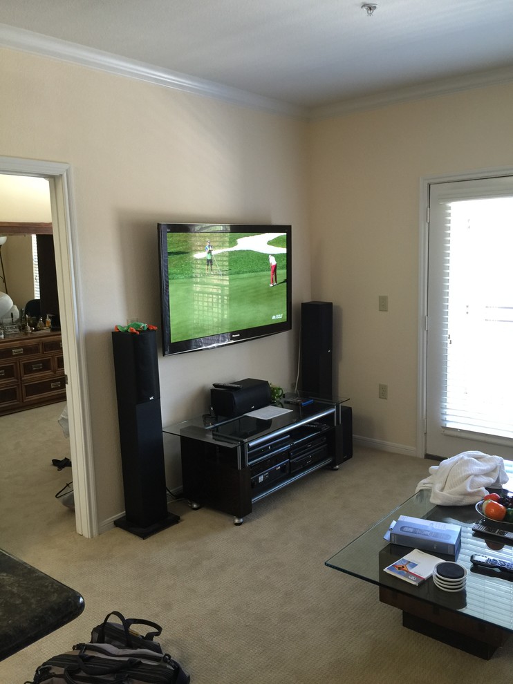 This is an example of a mid-sized traditional home theatre in Houston.