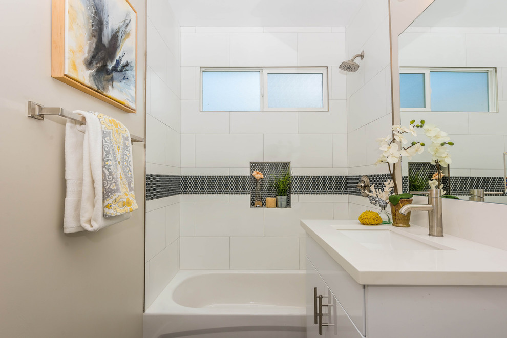 Alcove bathtub - coastal 3/4 white tile alcove bathtub idea in Los Angeles with flat-panel cabinets, white cabinets, beige walls, an undermount sink and white countertops