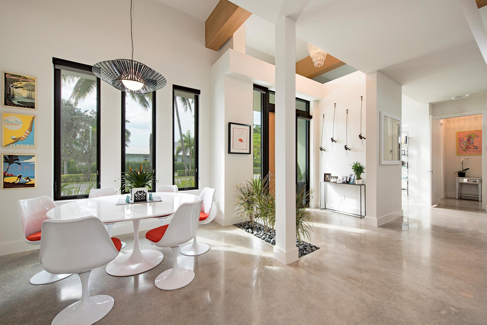 Inspiration for a small modern foyer in Miami with white walls, concrete floors and a single front door.