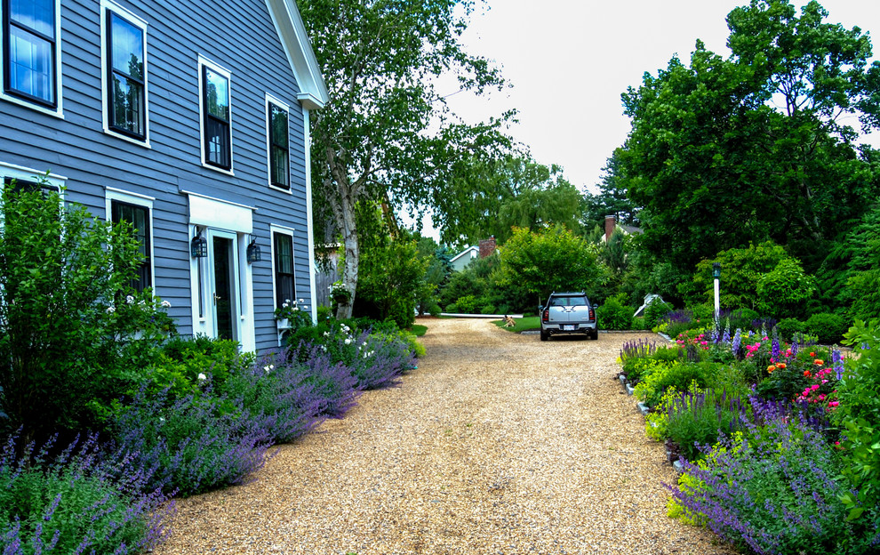 Design ideas for a mid-sized country courtyard full sun driveway for summer in Boston with gravel.