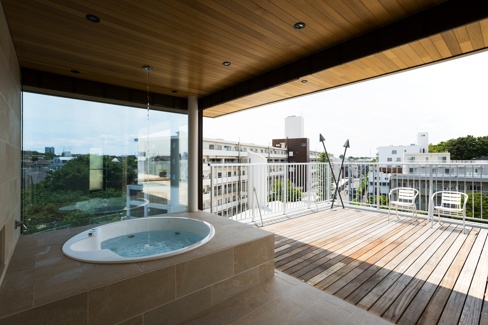 This is an example of a contemporary bathroom in Tokyo with a hot tub, beige tile, beige walls, beige floor and ceramic floors.