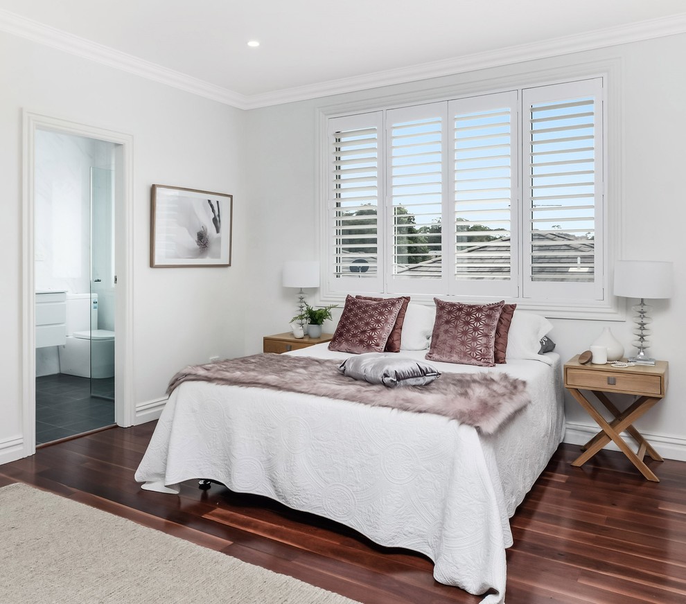 Design ideas for a transitional master bedroom in Sydney with beige walls, dark hardwood floors and red floor.