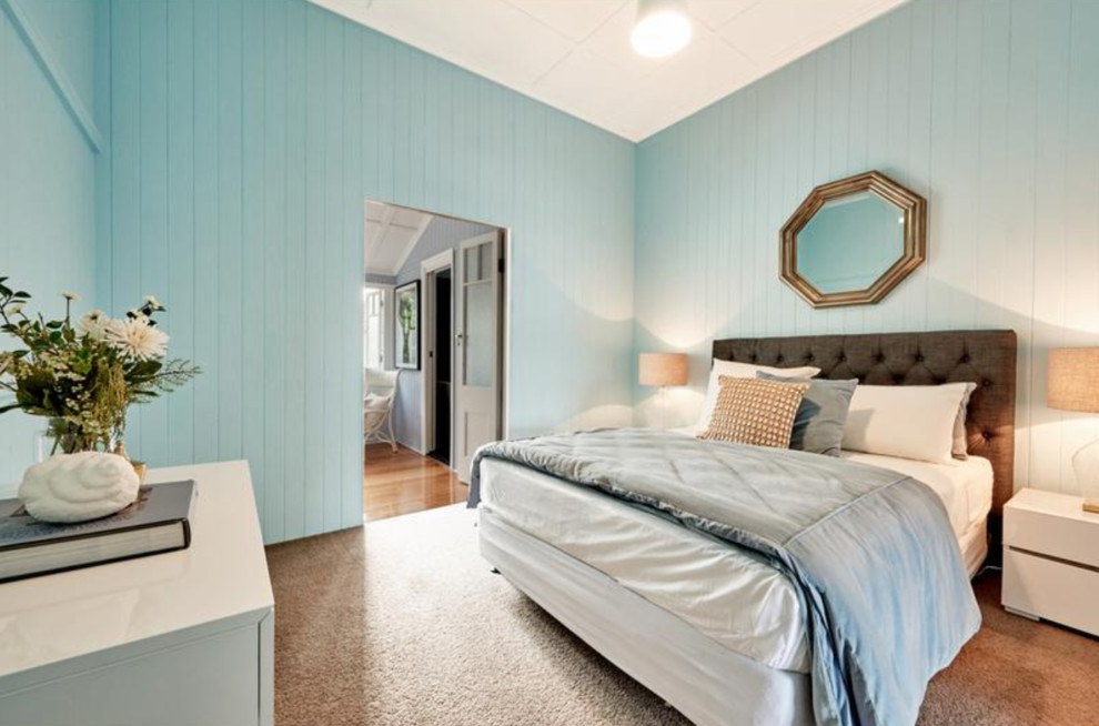 This is an example of a medium sized contemporary guest bedroom in Brisbane with blue walls, carpet and grey floors.