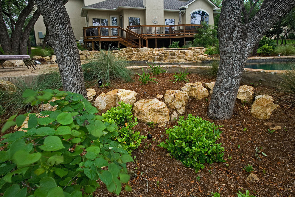 This is an example of a mid-sized rustic landscaping.