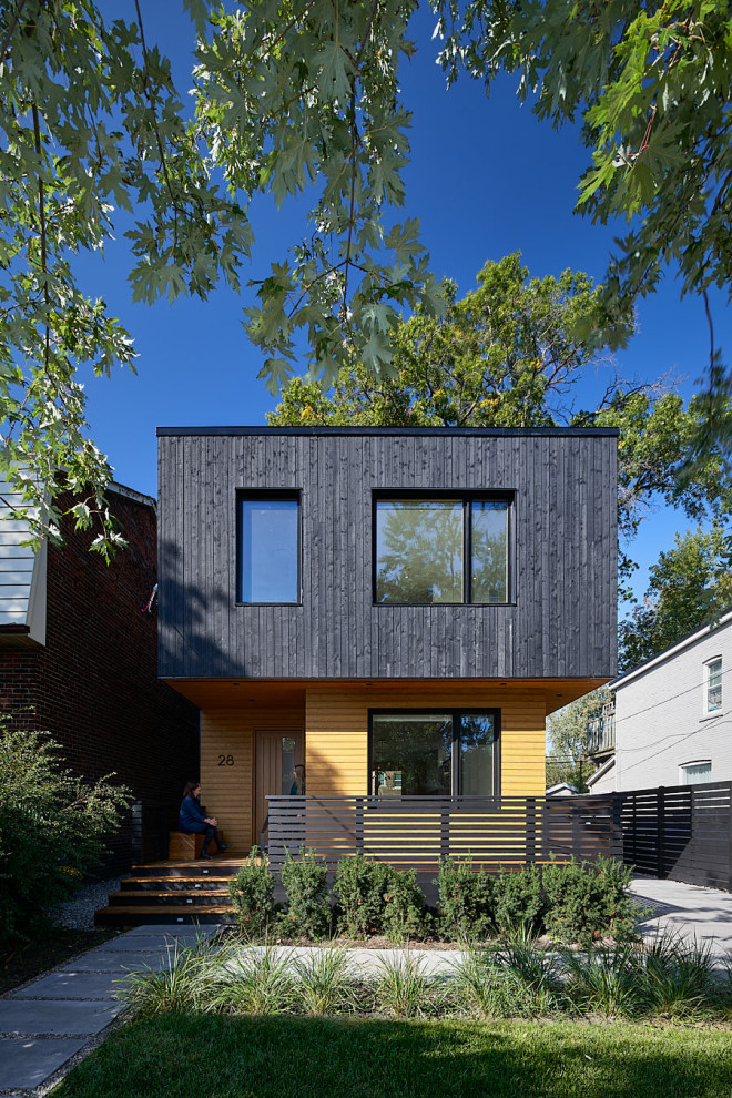 Design ideas for a scandinavian black house exterior in Vancouver.