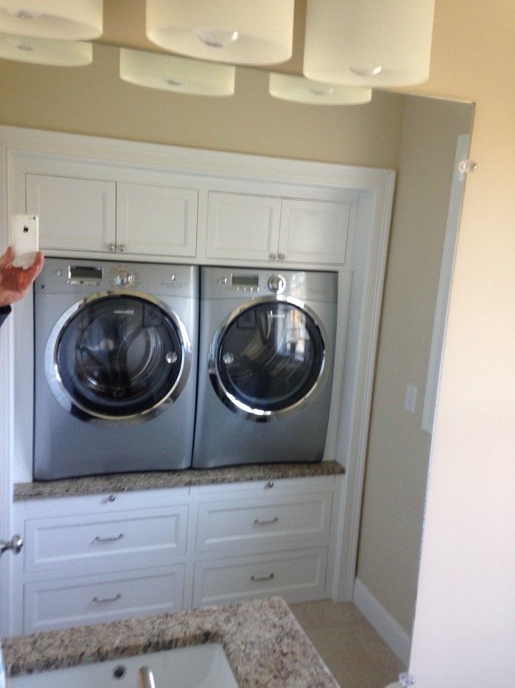 Inspiration for a contemporary laundry room remodel in Boston with flat-panel cabinets, white cabinets, granite countertops and a side-by-side washer/dryer