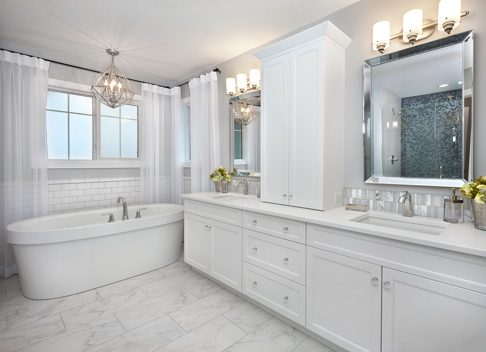 Large transitional master bathroom in Edmonton with an undermount sink, shaker cabinets, white cabinets, quartzite benchtops, a freestanding tub, an alcove shower, grey walls, porcelain floors, white tile and subway tile.
