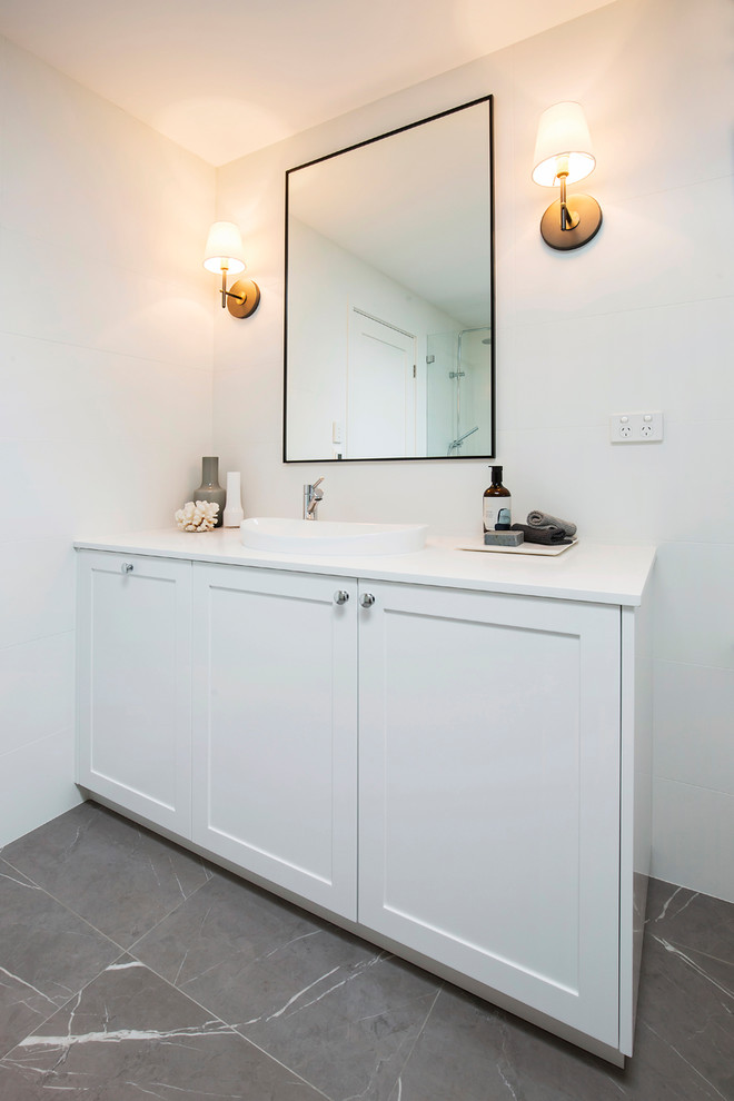 Large contemporary master bathroom in Sydney with shaker cabinets, white cabinets, a freestanding tub, an open shower, a wall-mount toilet, white tile, porcelain tile, white walls, porcelain floors, an integrated sink, engineered quartz benchtops, grey floor, an open shower and white benchtops.