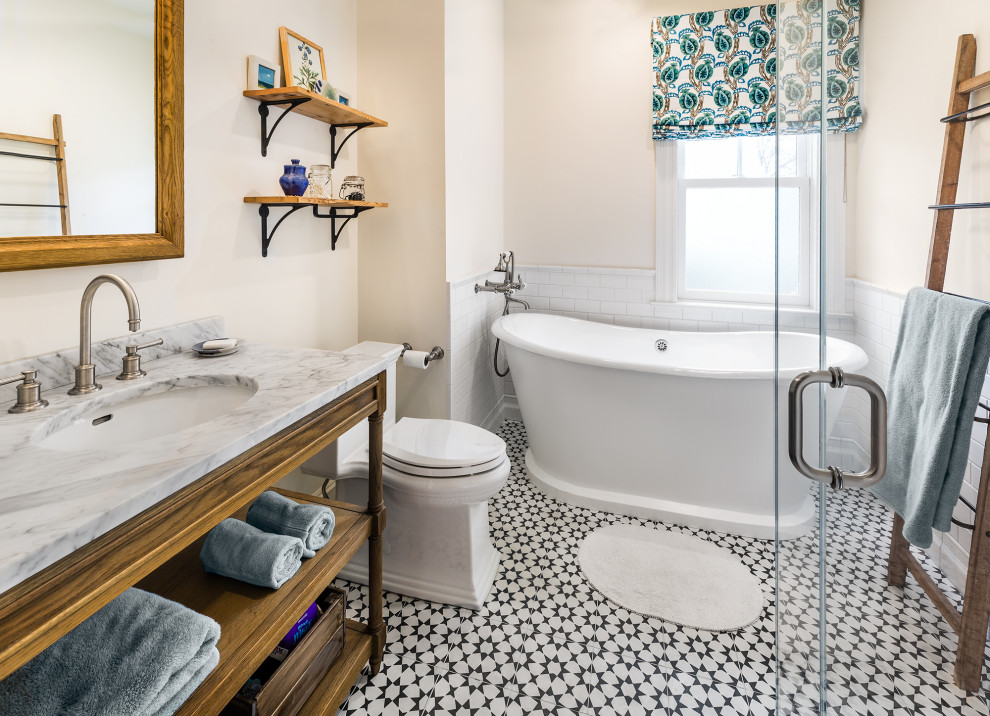 Inspiration for a small traditional bathroom in Boston with medium wood cabinets, a freestanding tub, white tile, ceramic tile, beige walls, ceramic floors, an undermount sink, marble benchtops, a hinged shower door, grey benchtops and a built-in vanity.