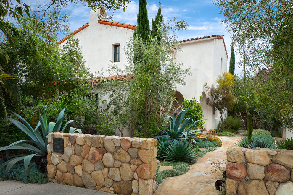 Photo of a mediterranean front yard garden in Santa Barbara with natural stone pavers.
