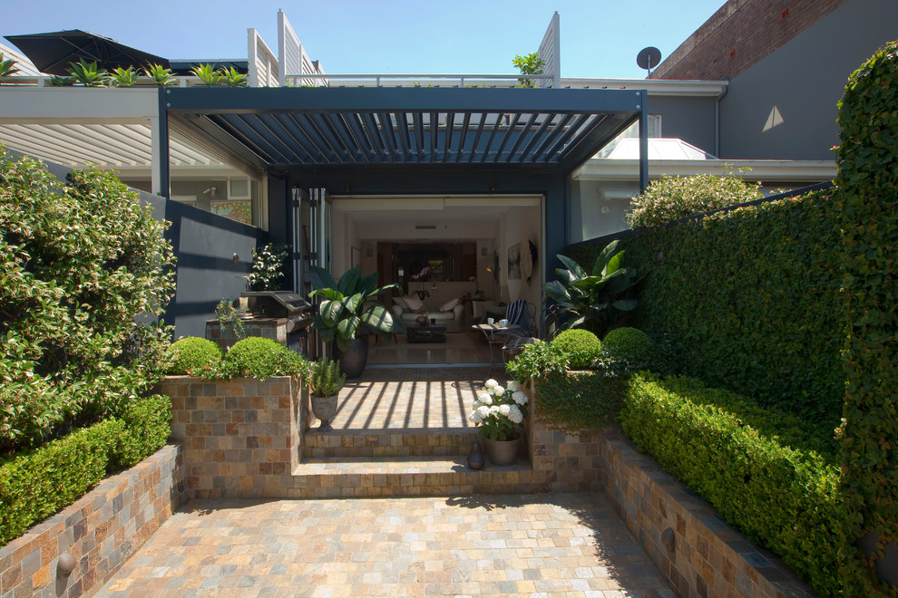 Small traditional courtyard formal garden in Sydney with natural stone pavers.