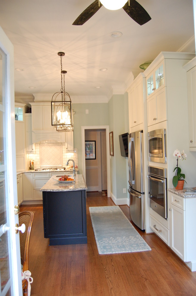 Transitional u-shaped eat-in kitchen photo in Raleigh with an undermount sink, recessed-panel cabinets, white cabinets, quartzite countertops, white backsplash, subway tile backsplash and stainless steel appliances