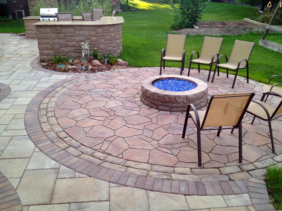 Photo of a large transitional backyard patio in Chicago with a fire feature and brick pavers.