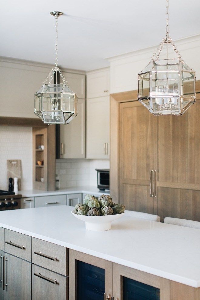 Eat-in kitchen - mid-sized transitional dark wood floor eat-in kitchen idea in Chicago with a farmhouse sink, shaker cabinets, gray cabinets, quartz countertops, white backsplash, ceramic backsplash, paneled appliances, an island and white countertops