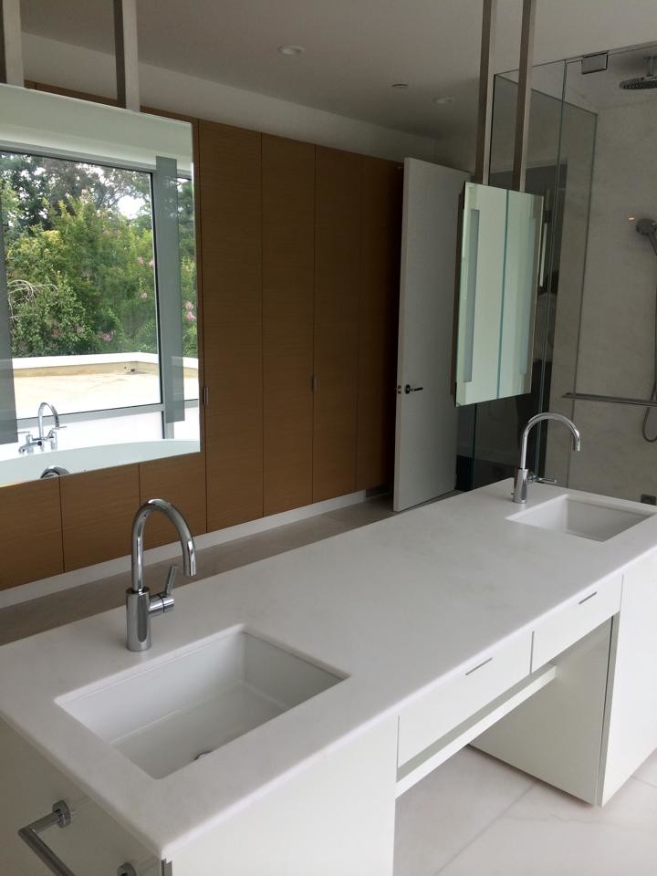 Large modern master bathroom in San Francisco with flat-panel cabinets, white cabinets, a freestanding tub, an open shower, white walls, marble floors, an undermount sink, quartzite benchtops, white floor, a hinged shower door and white benchtops.