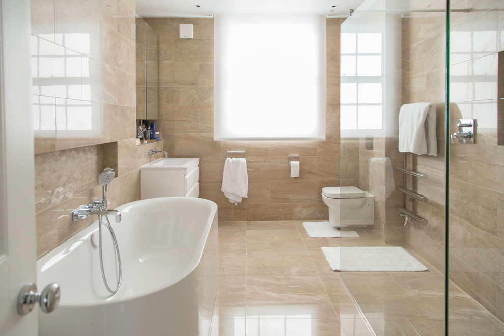 Design ideas for a large contemporary master bathroom in London with flat-panel cabinets, white cabinets, a freestanding tub, a corner shower, a wall-mount toilet, beige tile, beige walls, beige floor, an open shower, an integrated sink and white benchtops.