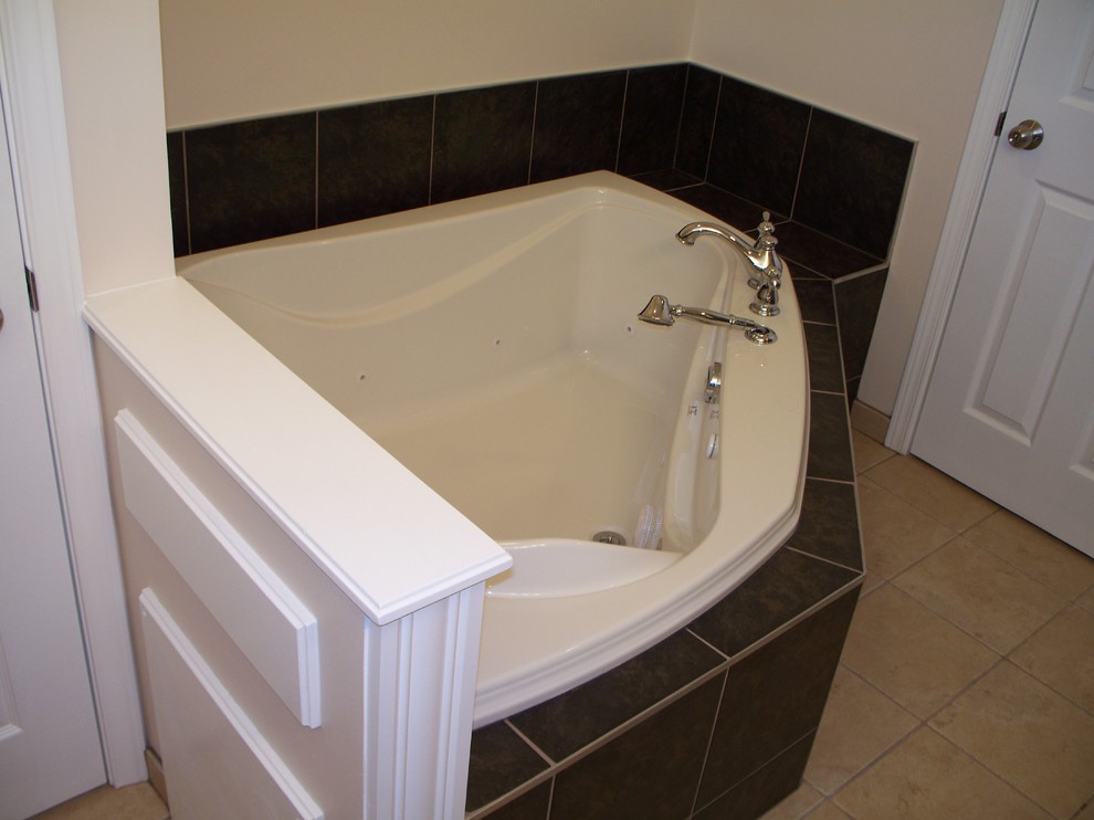 Photo of a large modern bathroom in Other with shaker cabinets, medium wood cabinets, a corner tub, a corner shower, black and white tile, ceramic tile, beige walls, ceramic floors, an undermount sink and granite benchtops.