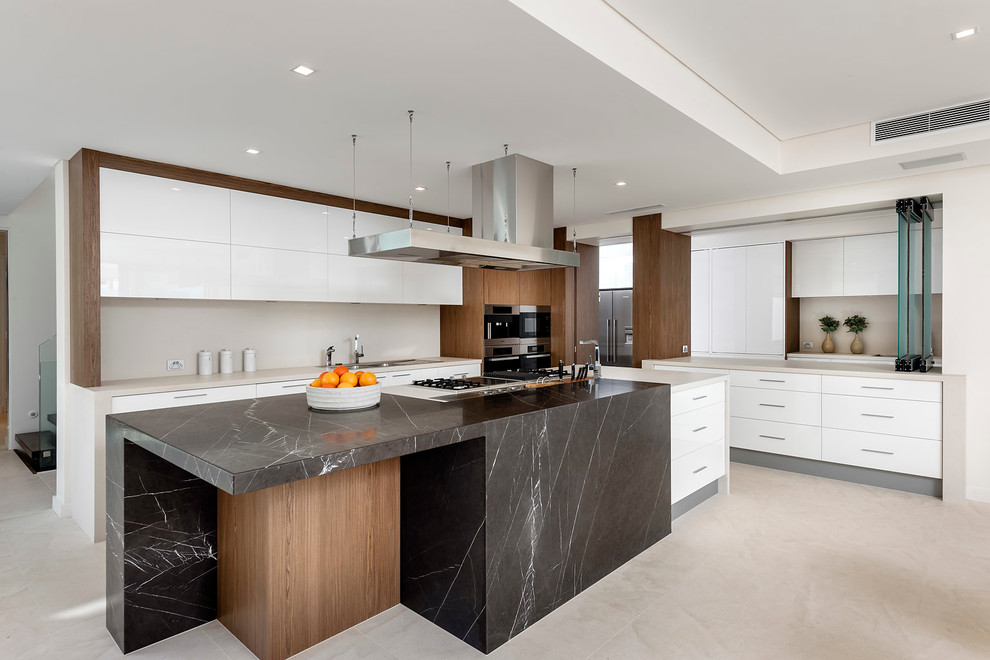 Photo of an expansive contemporary l-shaped open plan kitchen in Perth with stainless steel appliances, with island, flat-panel cabinets and beige benchtop.