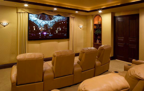Photo of a mid-sized mediterranean enclosed home theatre in Tampa with yellow walls, carpet and beige floor.