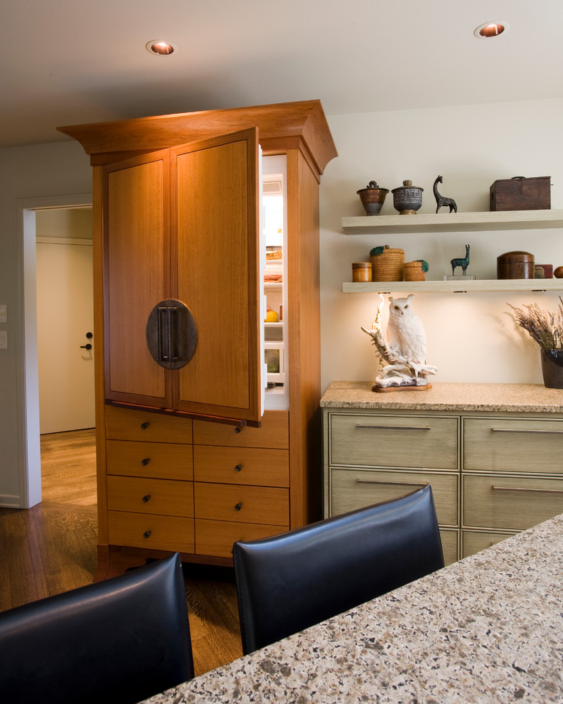 Design ideas for a transitional kitchen in Portland with medium wood cabinets and panelled appliances.