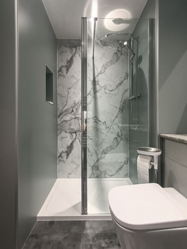 Design ideas for a small contemporary ensuite bathroom in Glasgow with flat-panel cabinets, grey cabinets, a walk-in shower, a one-piece toilet, green tiles, green walls, vinyl flooring, a built-in sink, laminate worktops, grey floors, an open shower, grey worktops, a feature wall, a single sink, a built in vanity unit, a drop ceiling and panelled walls.