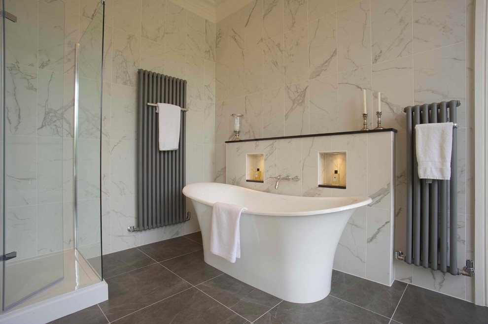 Large traditional bathroom in Other with a freestanding tub and white tile.