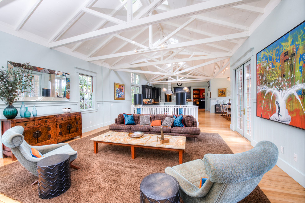 This is an example of a large country open concept family room in San Francisco with blue walls, medium hardwood floors and no tv.