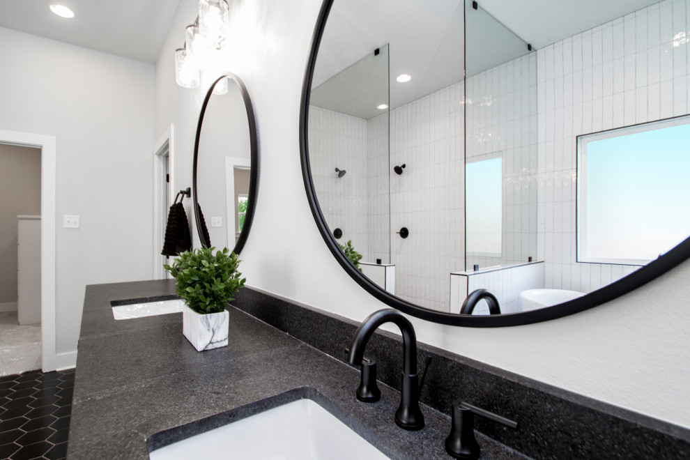 Inspiration for a mid-sized transitional master bathroom in Little Rock with recessed-panel cabinets, white cabinets, a drop-in tub, a curbless shower, a two-piece toilet, white tile, ceramic tile, grey walls, ceramic floors, an undermount sink, soapstone benchtops, black floor, an open shower and black benchtops.
