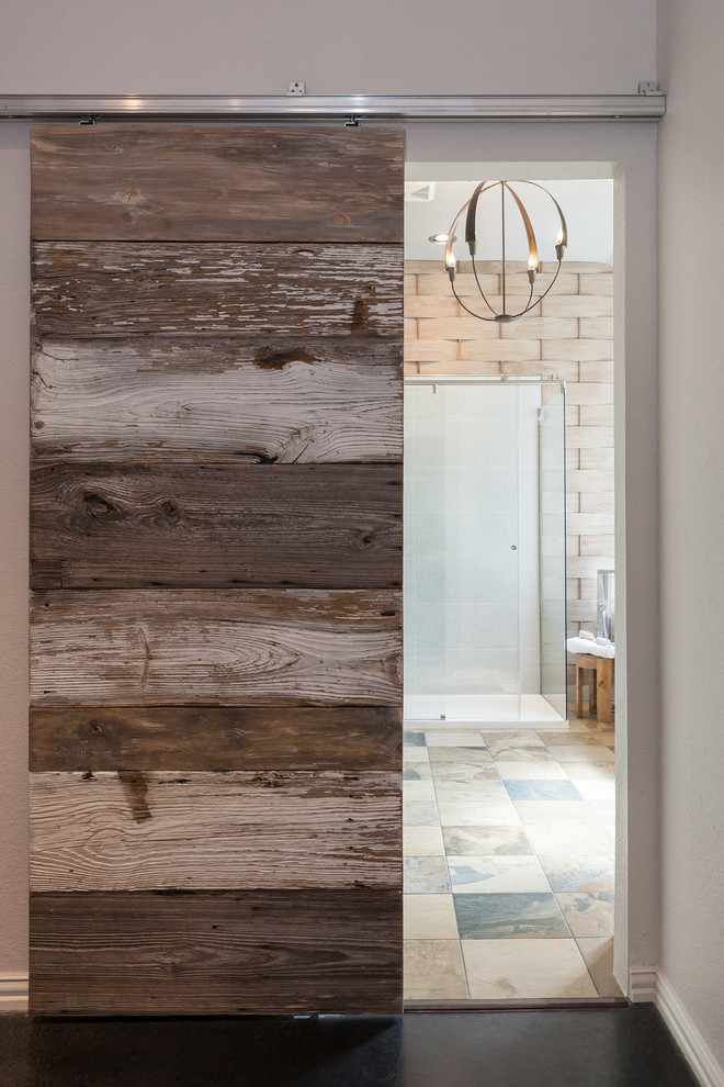 Photo of a mid-sized contemporary master bathroom in Dallas with flat-panel cabinets, medium wood cabinets, a freestanding tub, an alcove shower, beige tile, beige walls, slate floors, a trough sink and solid surface benchtops.
