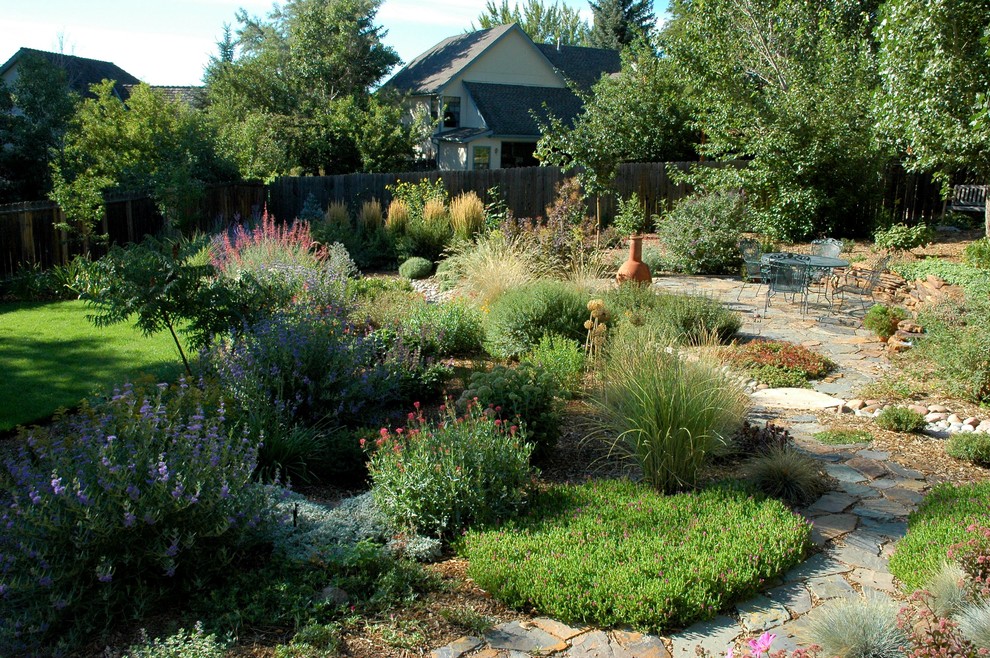 Inspiration for a large mediterranean backyard partial sun formal garden in Denver with a garden path and natural stone pavers.