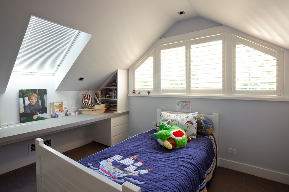 This is an example of a large transitional kids' bedroom for kids 4-10 years old and boys in Sydney with blue walls and carpet.