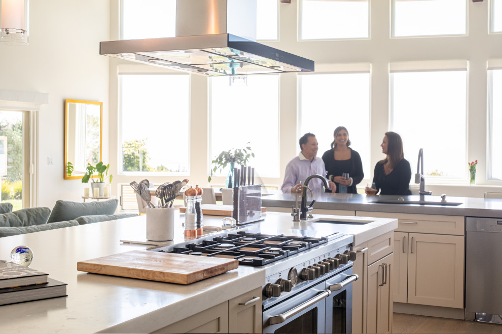 Eat-in kitchen - large transitional l-shaped light wood floor and white floor eat-in kitchen idea with an undermount sink, shaker cabinets, gray cabinets, marble countertops, white backsplash, subway tile backsplash, stainless steel appliances, an island and white countertops