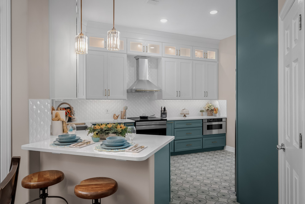 Transitional ceramic tile kitchen photo in Austin with an undermount sink, shaker cabinets, white backsplash, porcelain backsplash, stainless steel appliances and white countertops