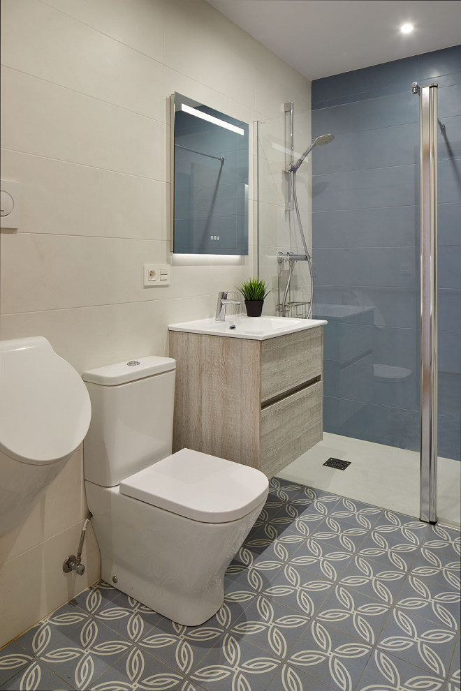 Design ideas for a large 3/4 bathroom in Other with white cabinets, a curbless shower, an urinal, blue tile, ceramic tile, blue walls, ceramic floors, a drop-in sink, blue floor, a hinged shower door, a single vanity and a floating vanity.
