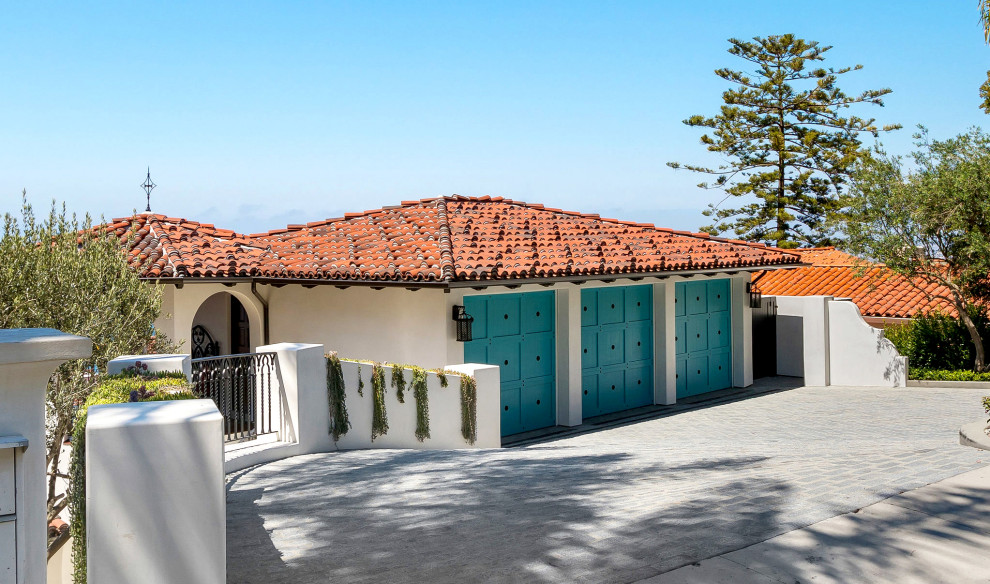 Design ideas for an expansive mediterranean split-level stucco white house exterior in Los Angeles with a tile roof and a red roof.