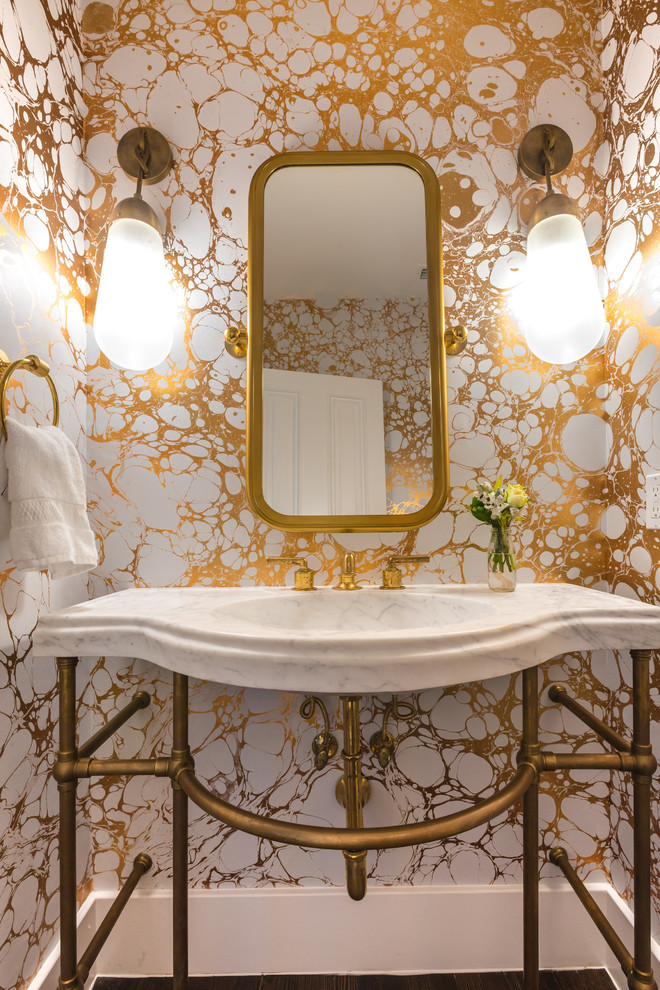 Photo of a contemporary powder room in Austin with yellow walls and a console sink.