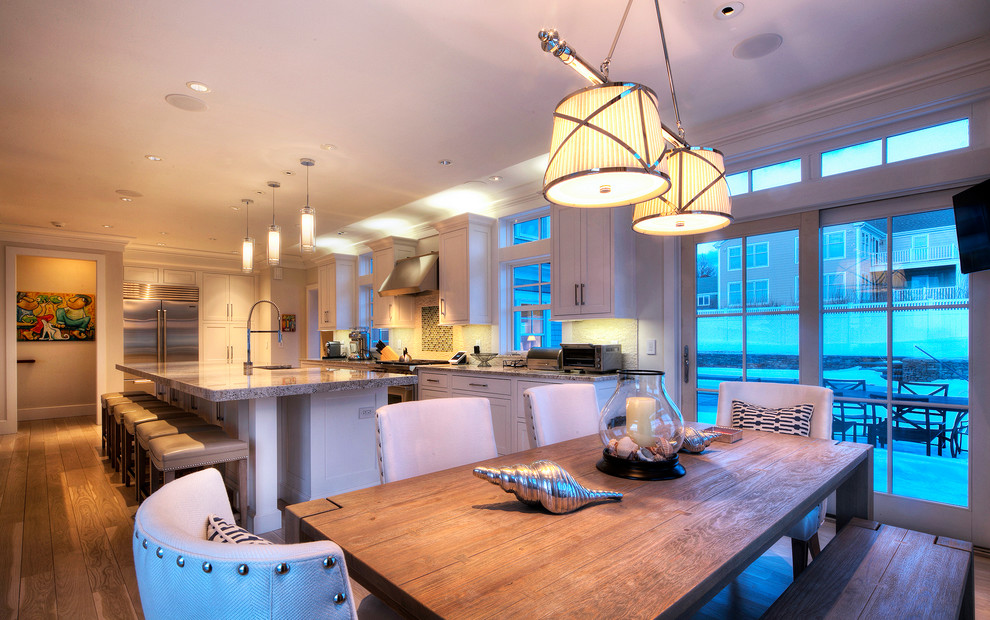 Open concept kitchen - large transitional single-wall light wood floor and beige floor open concept kitchen idea in Providence with a farmhouse sink, beaded inset cabinets, white cabinets, granite countertops, beige backsplash, mosaic tile backsplash, stainless steel appliances and an island