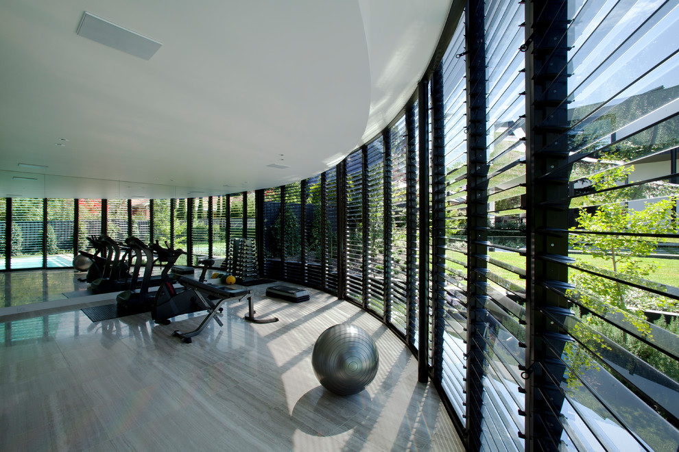 Contemporary home weight room with white walls.