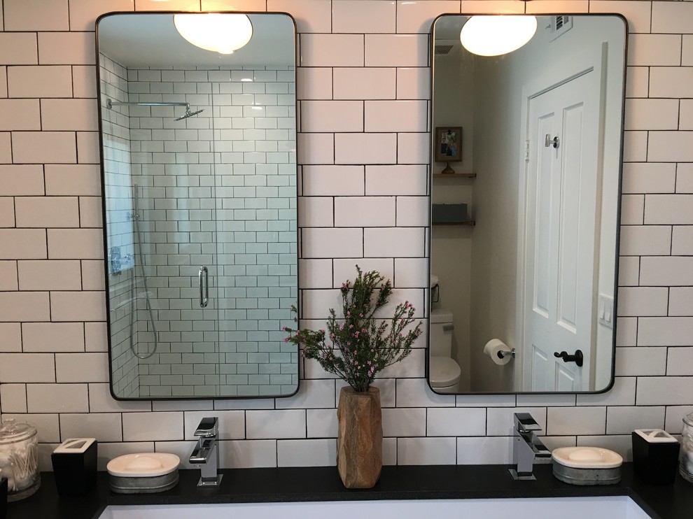 Photo of a mid-sized industrial kids bathroom in Los Angeles with open cabinets, medium wood cabinets, an alcove shower, a one-piece toilet, white tile, subway tile, white walls, ceramic floors, a trough sink and granite benchtops.