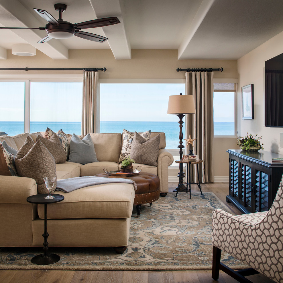Photo of a mid-sized beach style open concept family room in Orange County with brown walls, dark hardwood floors, a wall-mounted tv and brown floor.