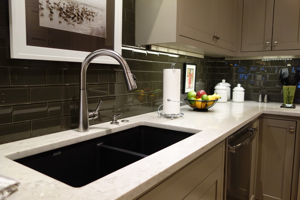 Example of a small transitional u-shaped ceramic tile home design design with an undermount sink, shaker cabinets, gray cabinets, quartz countertops, gray backsplash, glass tile backsplash, stainless steel appliances and a peninsula