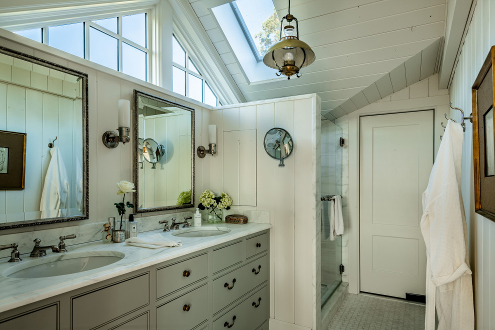 Traditional bathroom in Seattle with beaded inset cabinets, grey cabinets, an alcove shower, white walls, mosaic tile floors, an undermount sink, grey floor, a hinged shower door, white benchtops, a double vanity, a built-in vanity, vaulted and planked wall panelling.