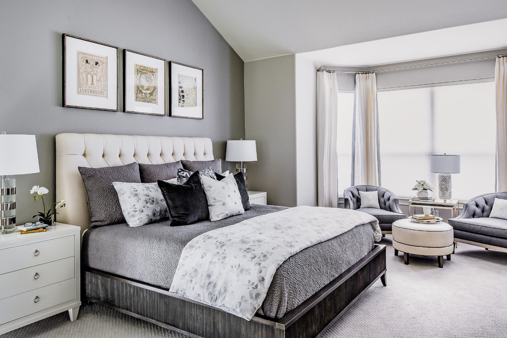 This is an example of a mid-sized transitional master bedroom in Austin with grey walls and carpet.