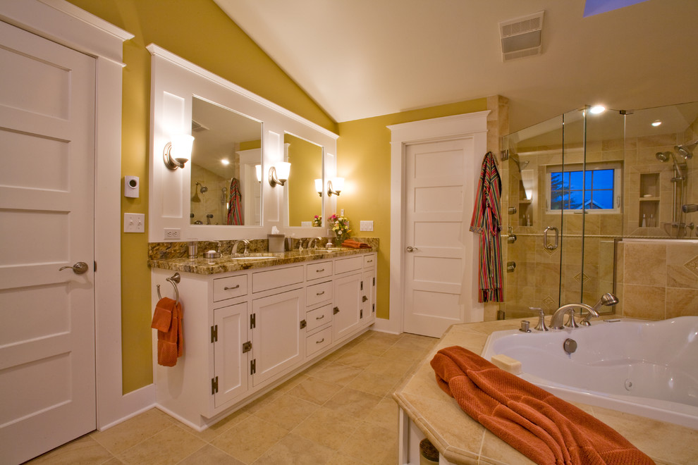 Inspiration for a large traditional master bathroom in Charleston with an undermount sink, recessed-panel cabinets, white cabinets, granite benchtops, a drop-in tub, a double shower, a two-piece toilet, yellow tile and porcelain tile.