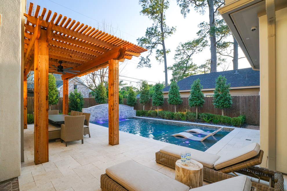 Small contemporary backyard rectangular natural pool in Houston with a water feature.