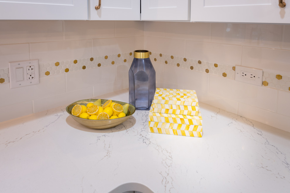 Inspiration for a large transitional u-shaped porcelain tile and gray floor open concept kitchen remodel in Chicago with an undermount sink, shaker cabinets, white cabinets, quartz countertops, white backsplash, ceramic backsplash, stainless steel appliances, an island and white countertops