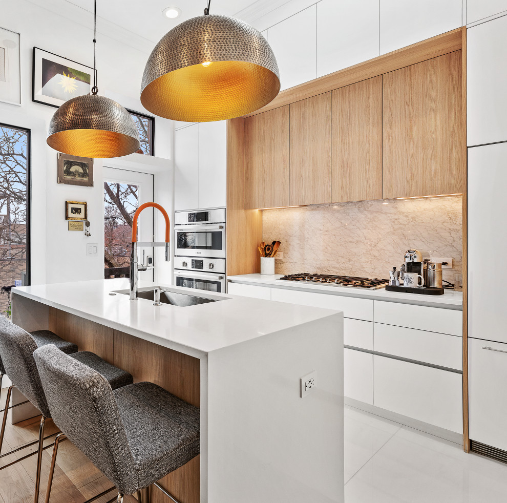 Open concept kitchen - small contemporary single-wall light wood floor open concept kitchen idea in Chicago with an undermount sink, flat-panel cabinets, quartz countertops, paneled appliances, an island and white countertops